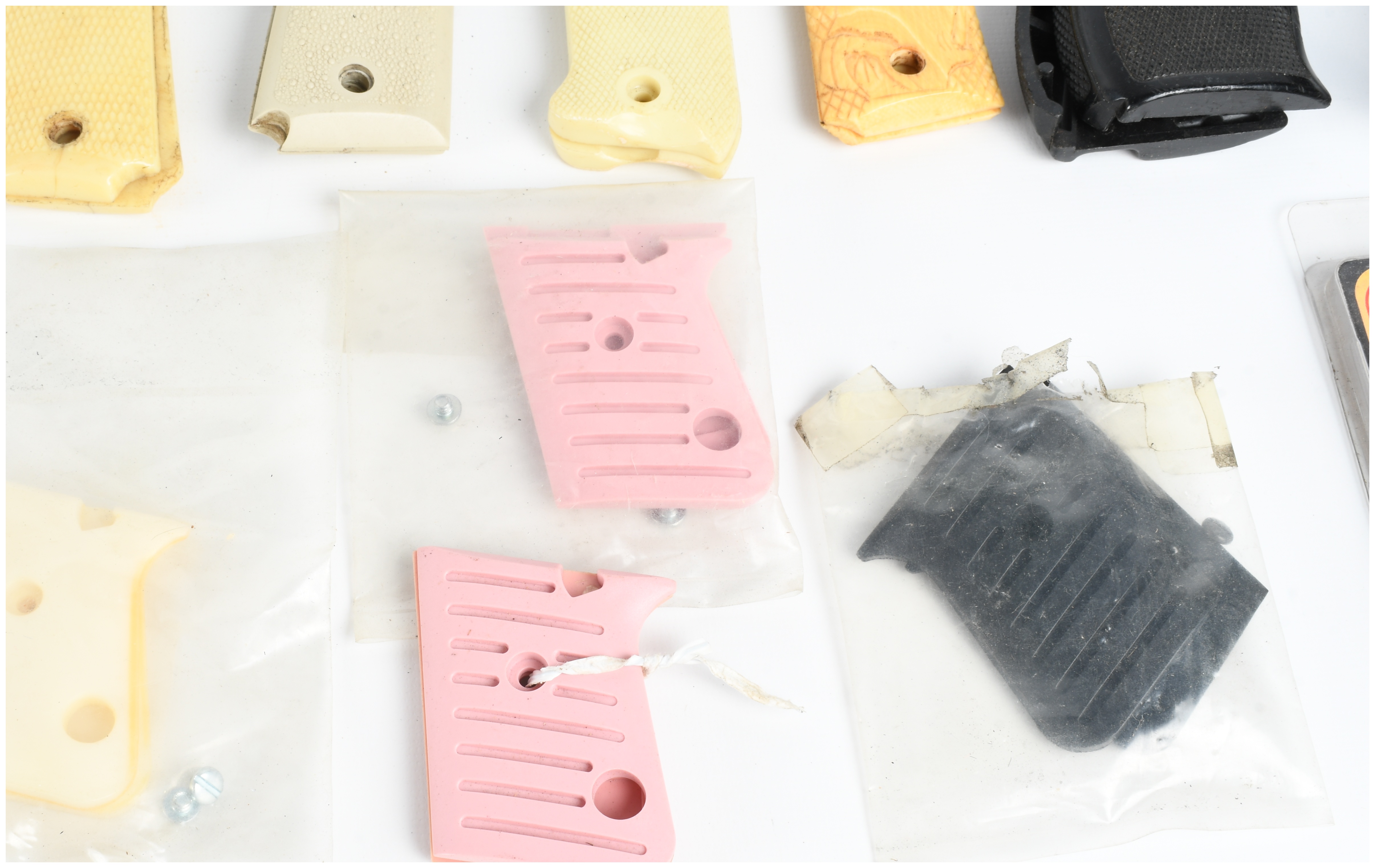A Collection of 18 Assorted Handgun Grips and Accessories including Pearce Grip and Hogue Examples