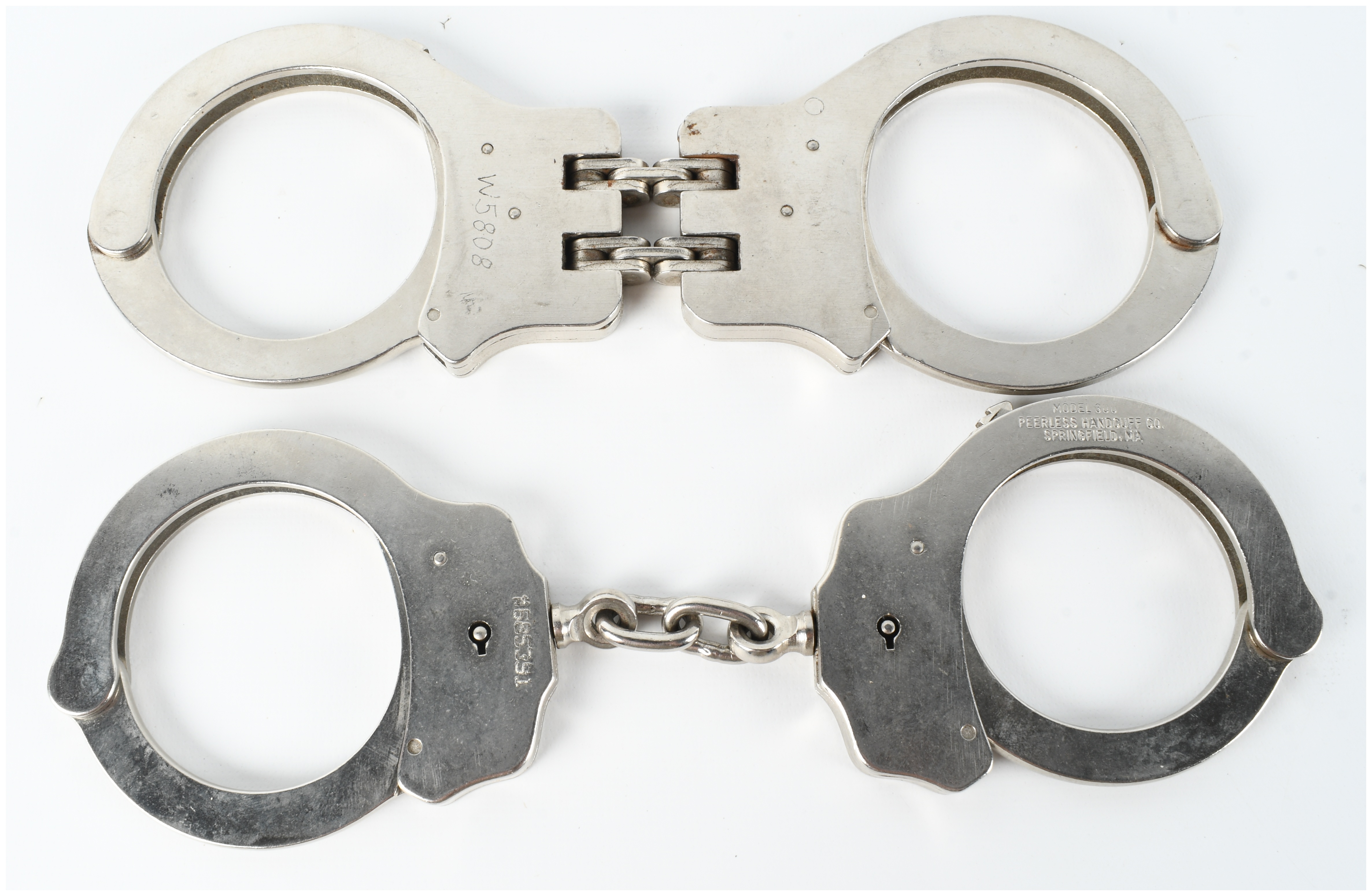 Two Pairs of Peerless Handcuffs Including Model 300 and Hinged Model