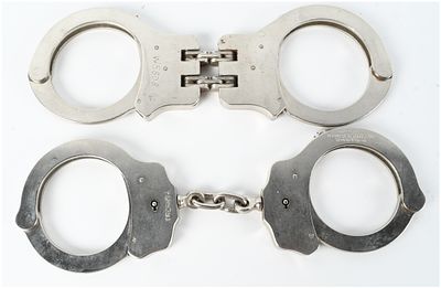 Two Pairs of Peerless Handcuffs Including Model 300 and Hinged Model. This lot features two 