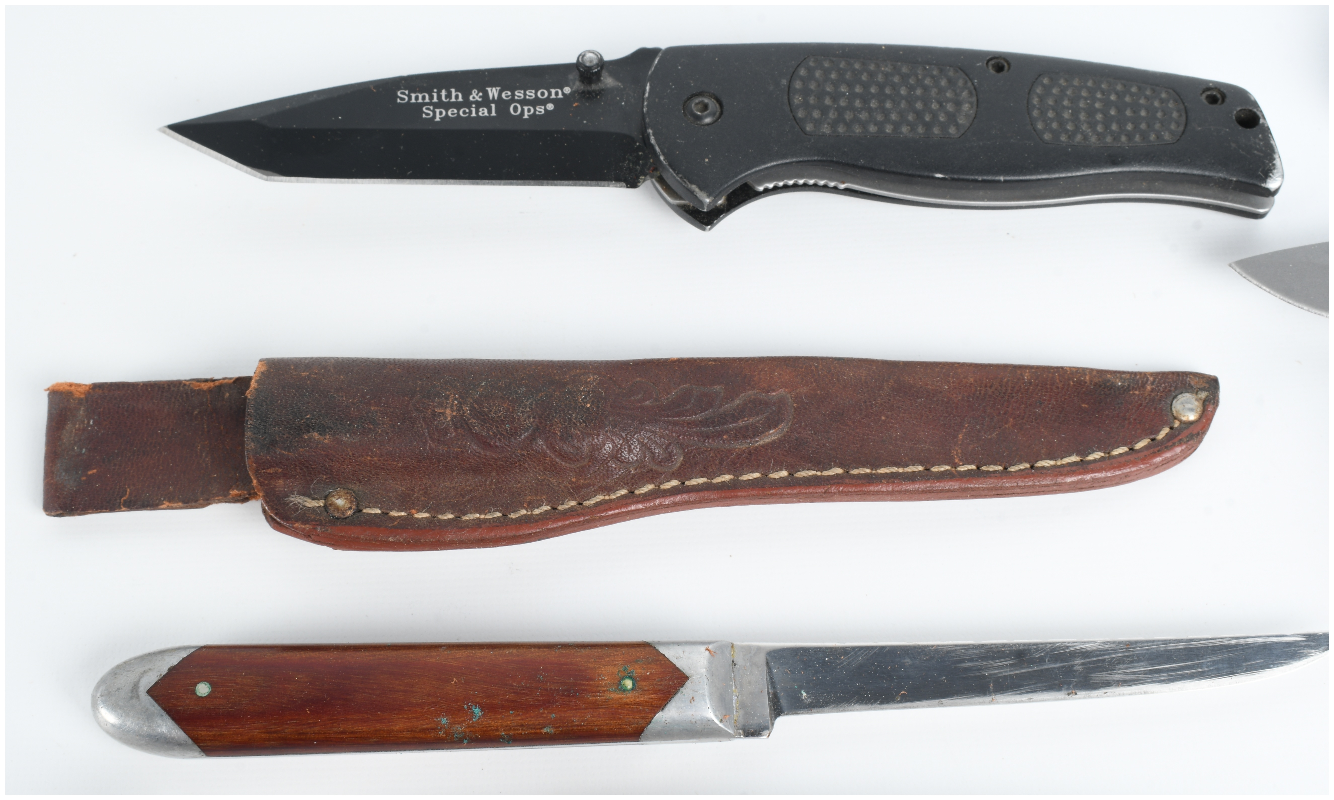 A Collection of Five Knives Including Buck and Smith & Wesson Models
