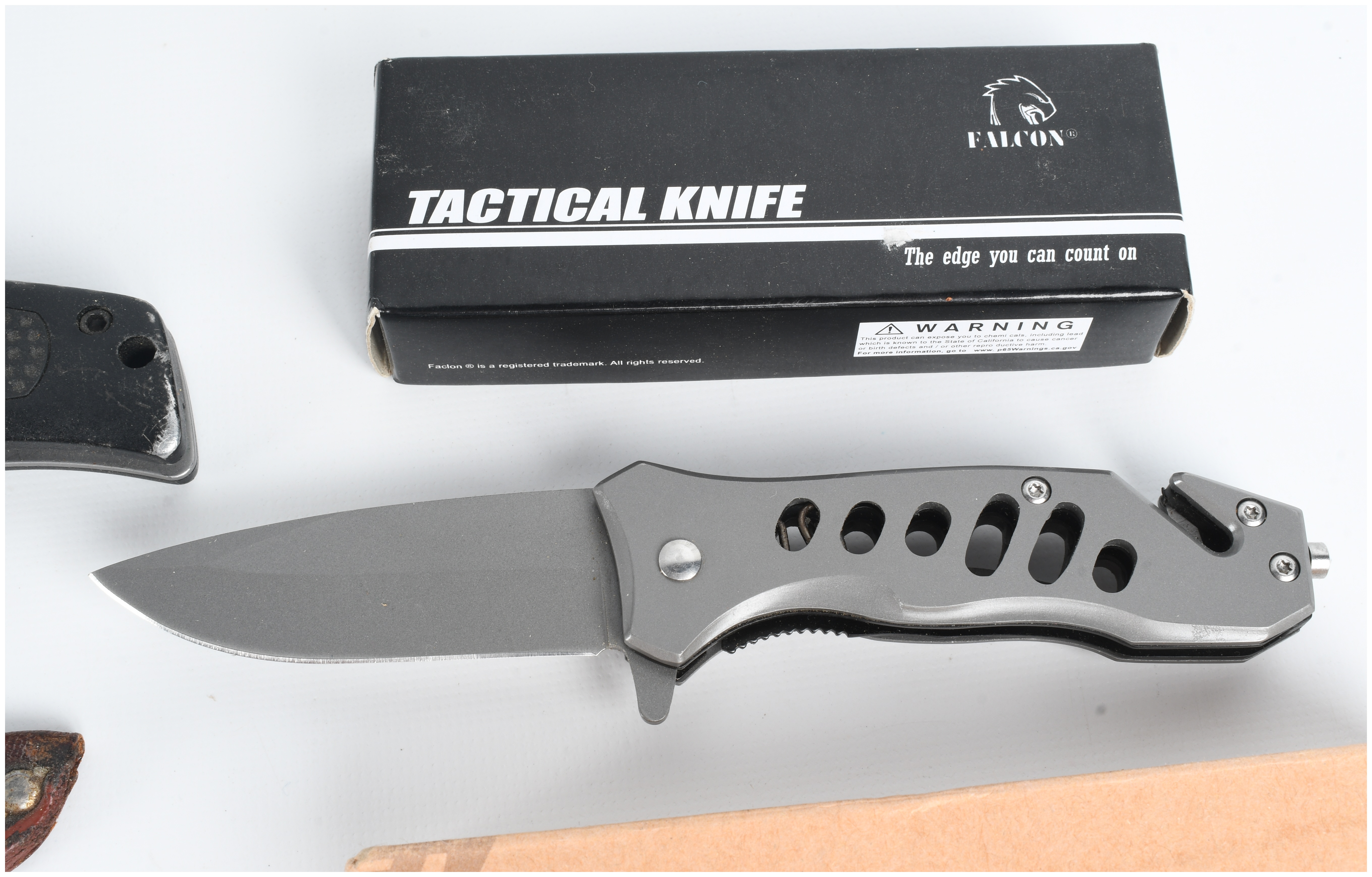 A Collection of Five Knives Including Buck and Smith & Wesson Models
