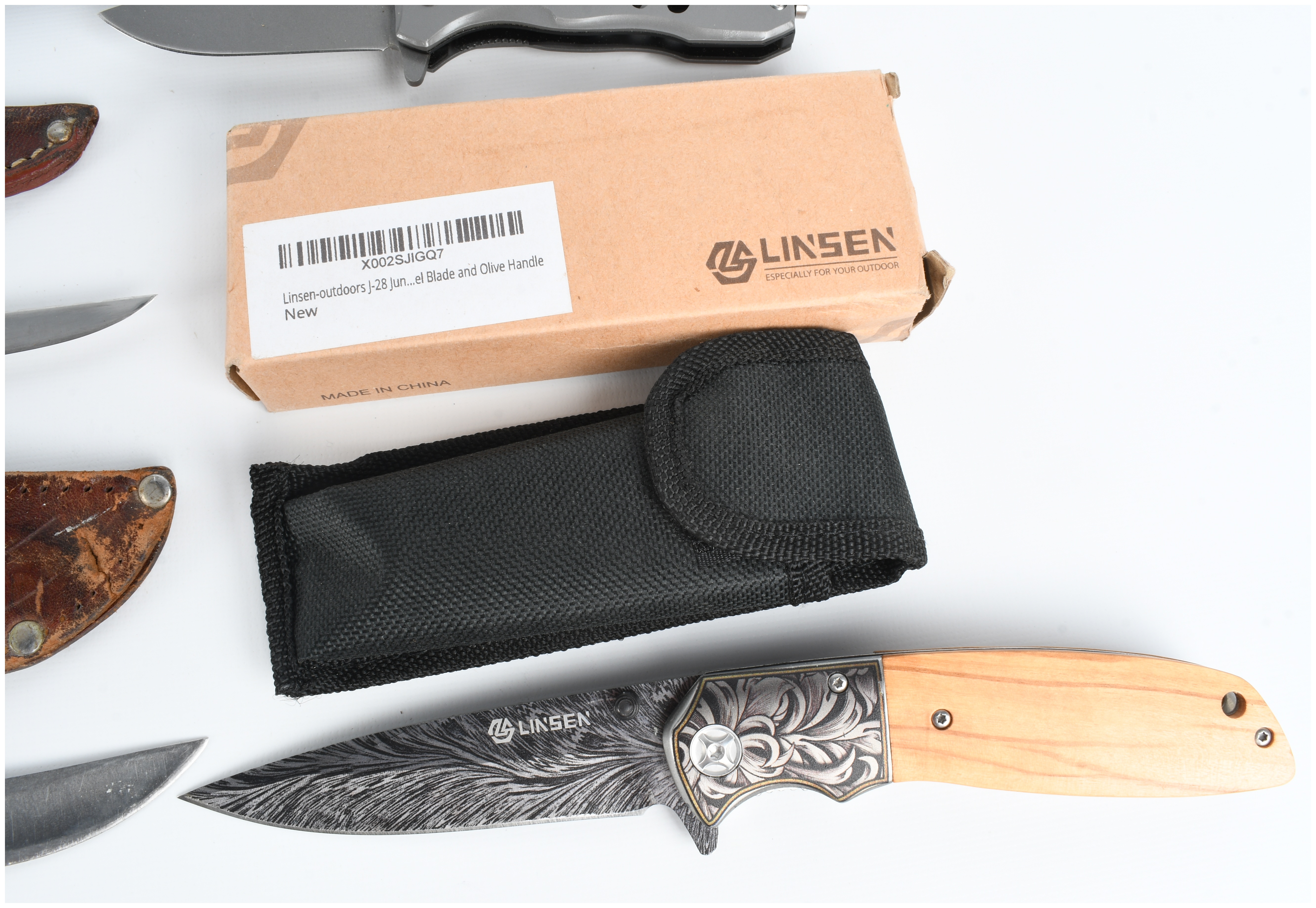 A Collection of Five Knives Including Buck and Smith & Wesson Models