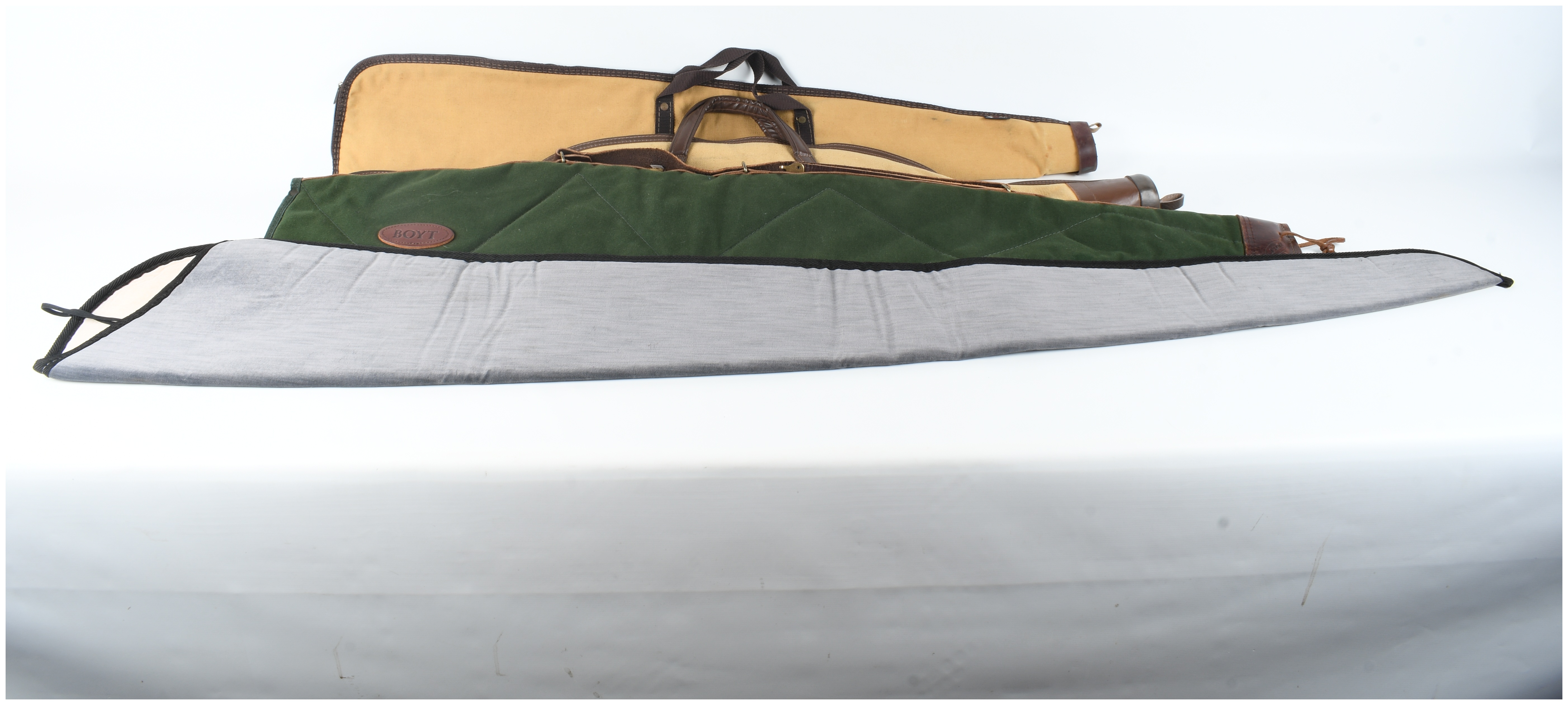 A Set of Four Gun Cases and Protective Slips Including Boyt