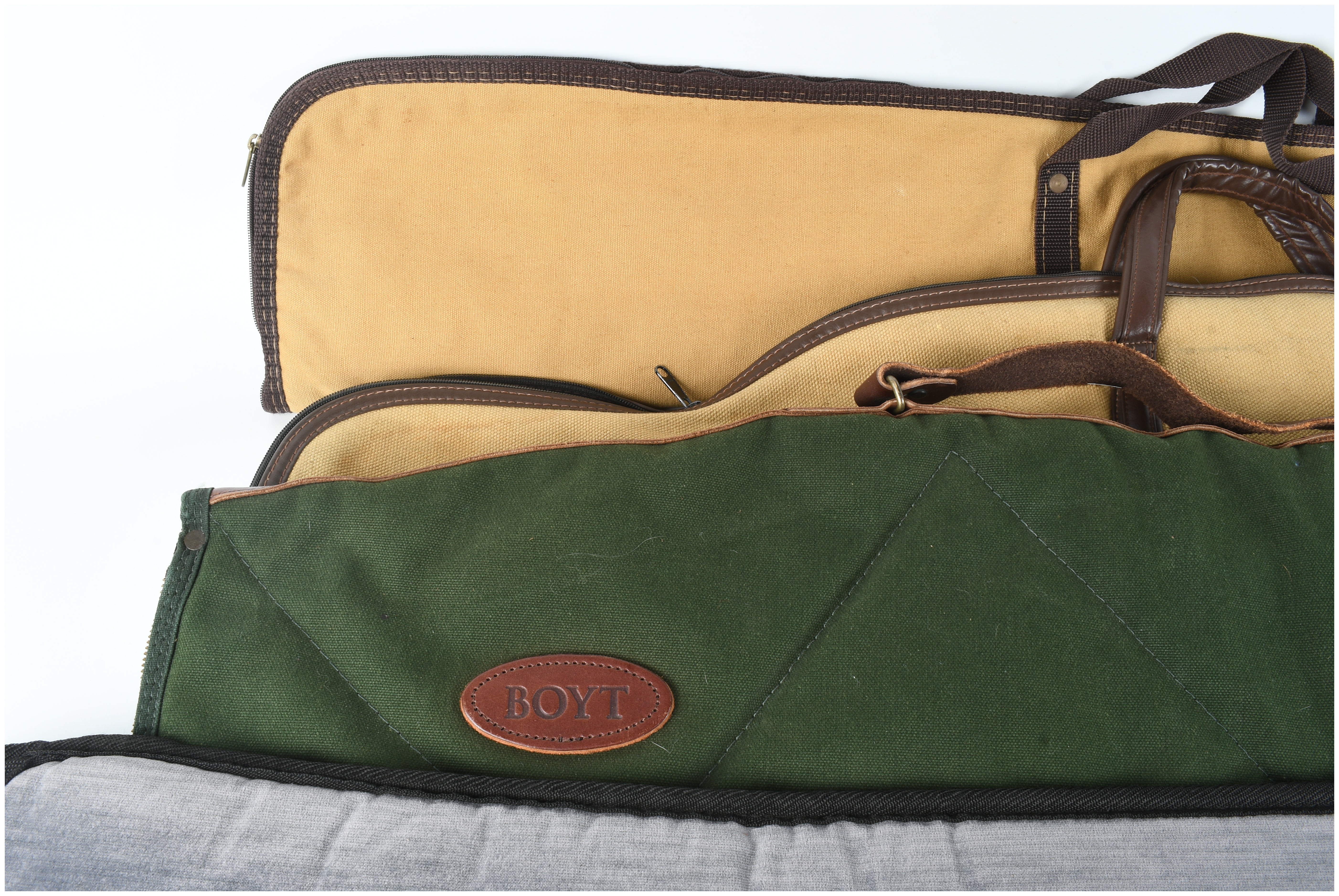 A Set of Four Gun Cases and Protective Slips Including Boyt
