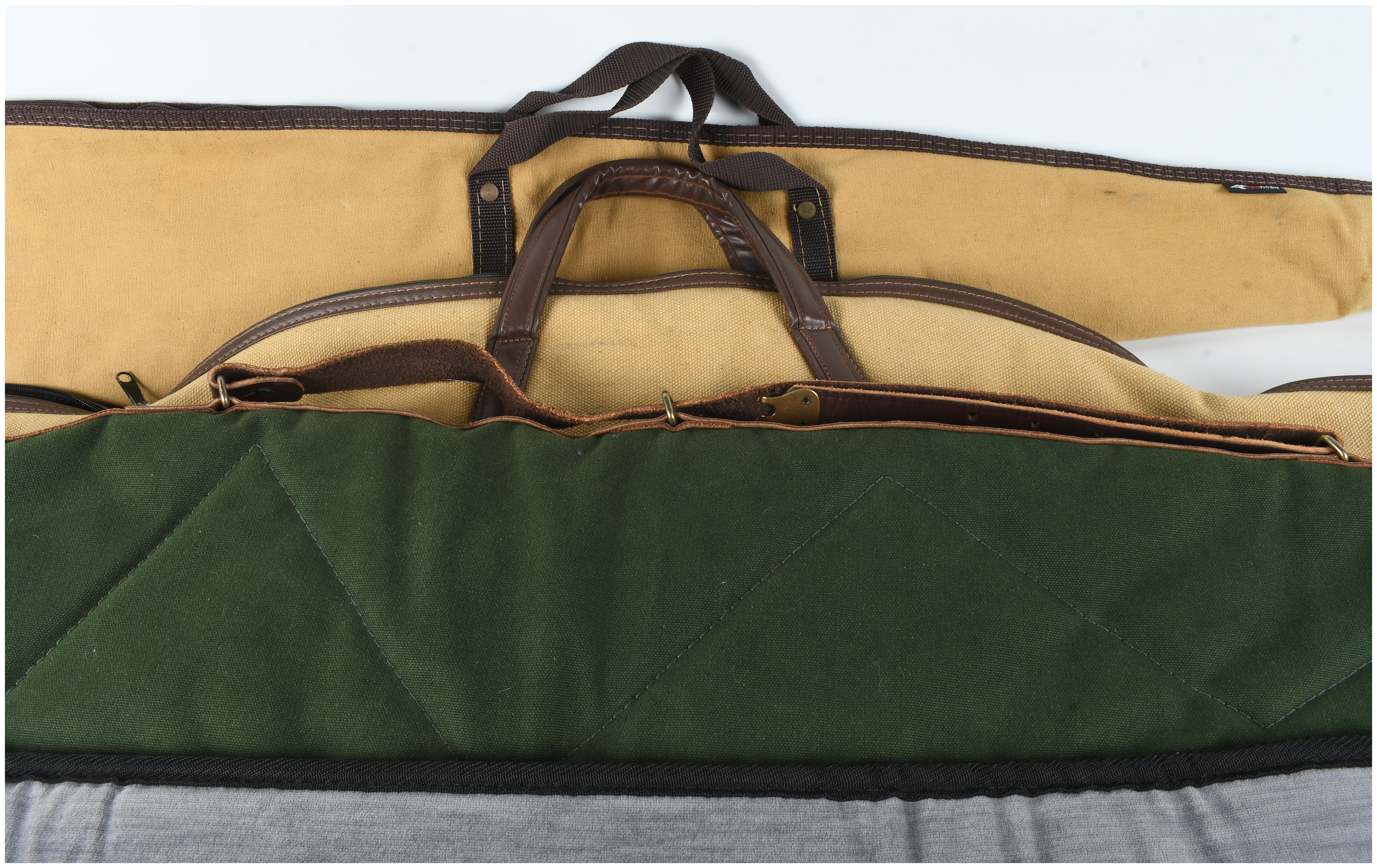 A Set of Four Gun Cases and Protective Slips Including Boyt