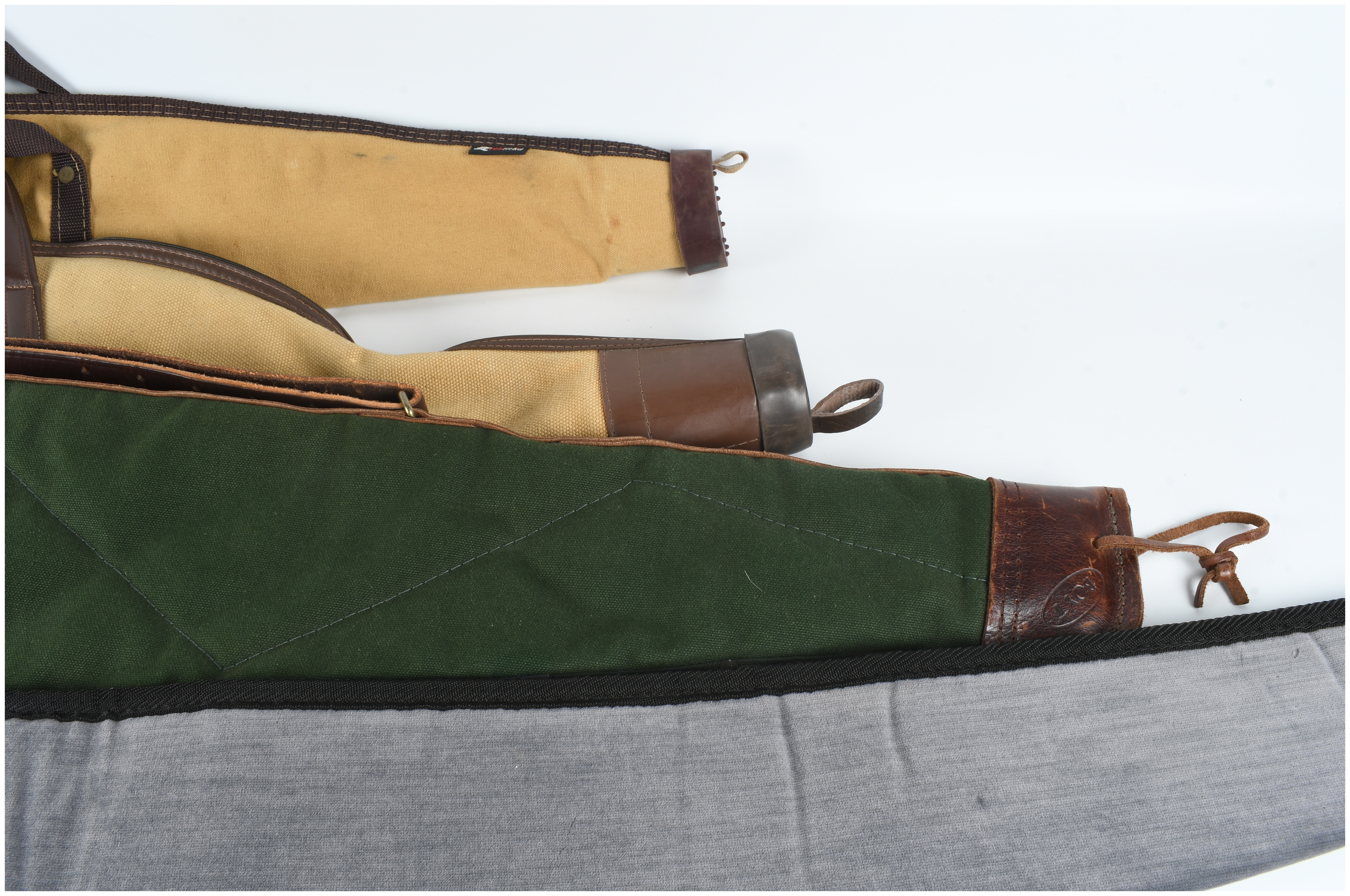 A Set of Four Gun Cases and Protective Slips Including Boyt
