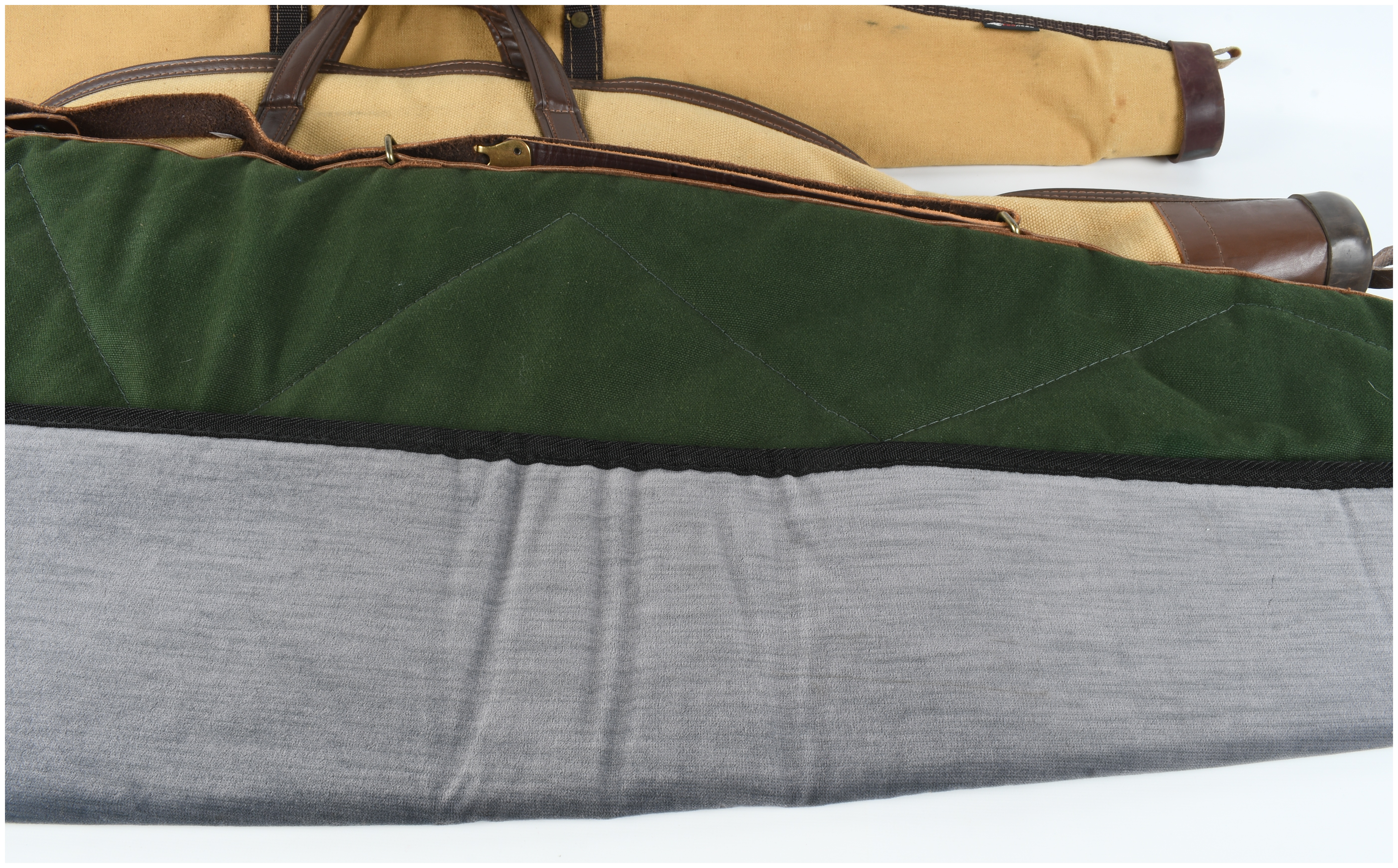A Set of Four Gun Cases and Protective Slips Including Boyt