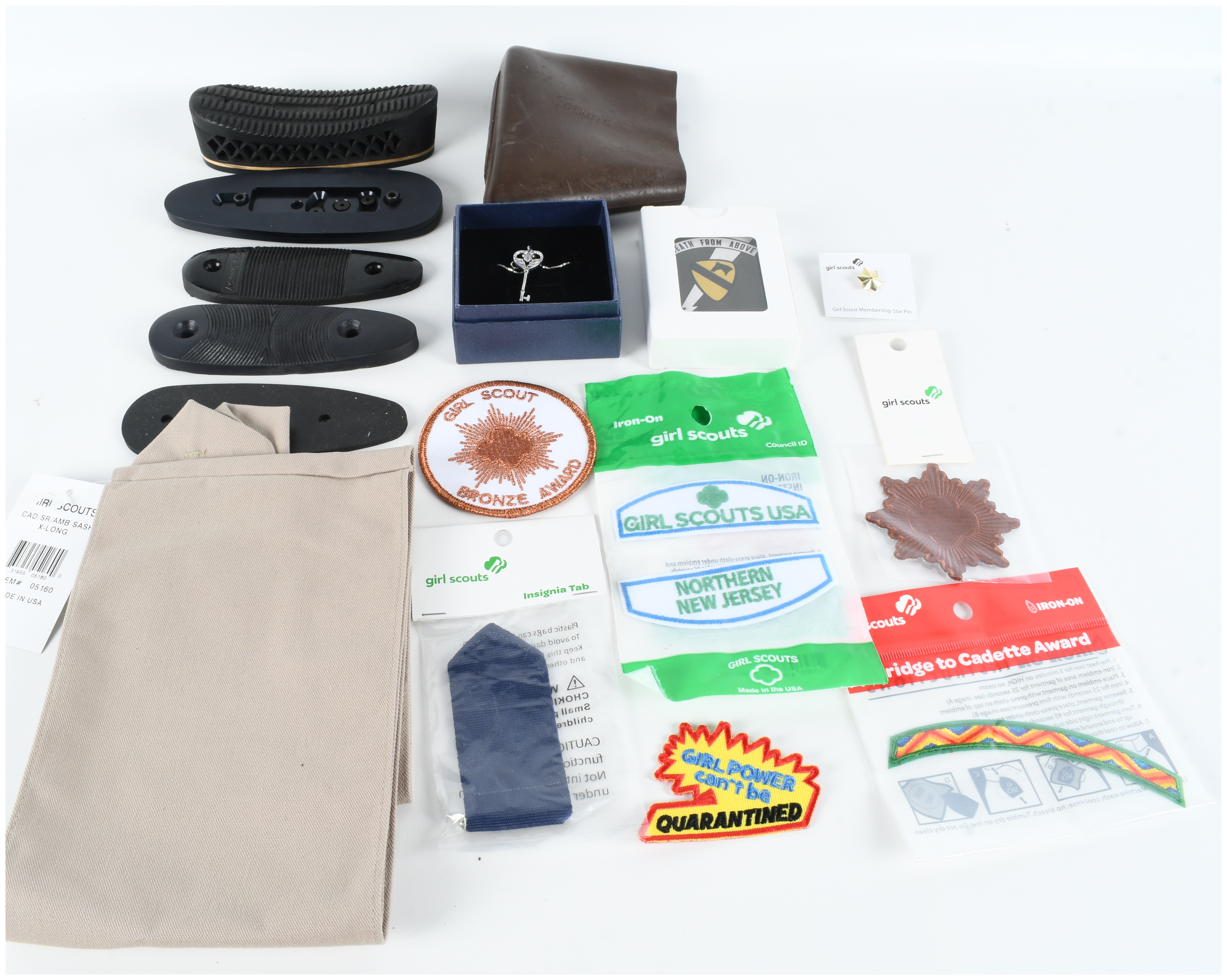 An Assortment of Firearm Recoil Pads, Girl Scout Memorabilia, and Full Deck Apocalypse Now Death Cards