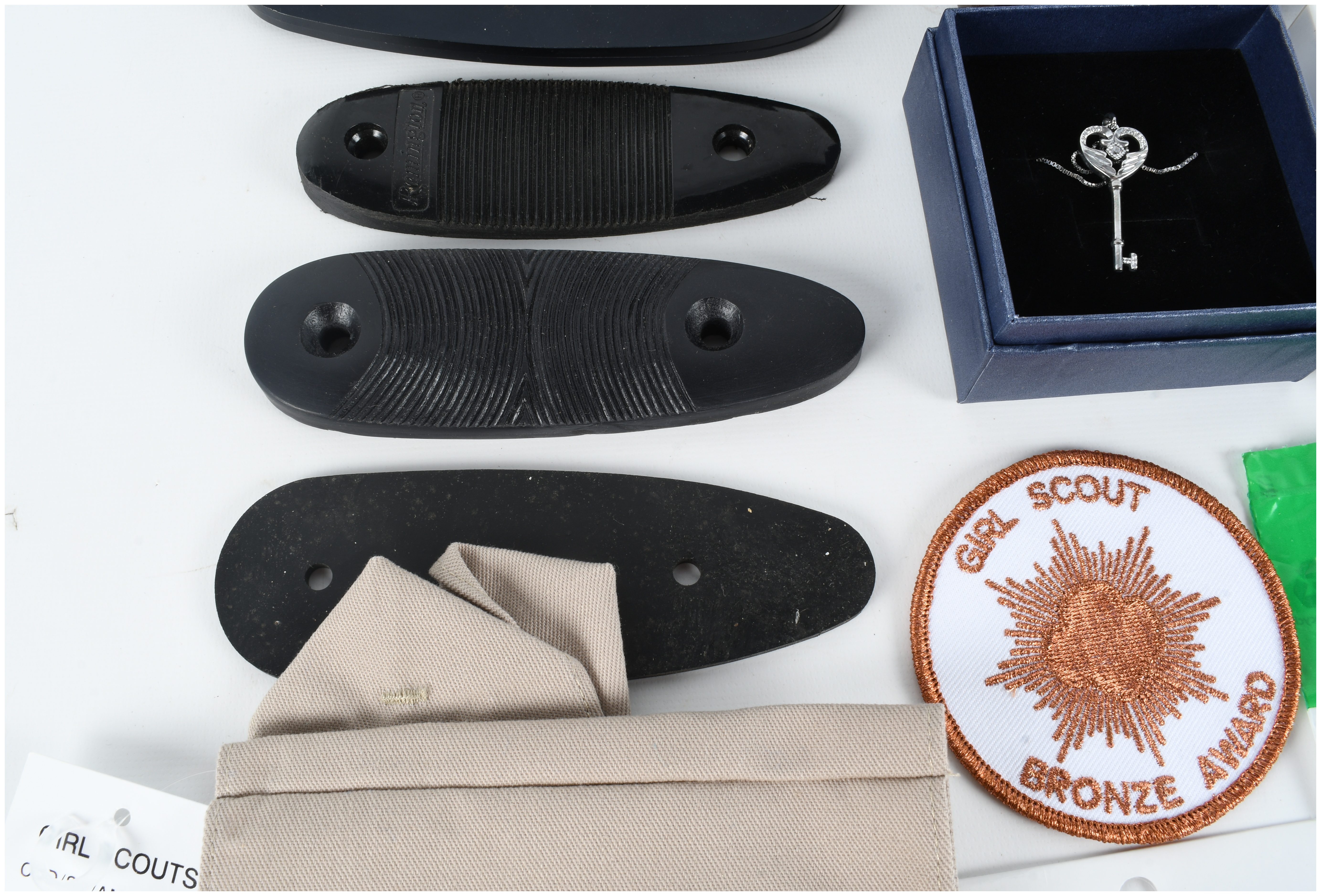 An Assortment of Firearm Recoil Pads, Girl Scout Memorabilia, and Full Deck Apocalypse Now Death Cards