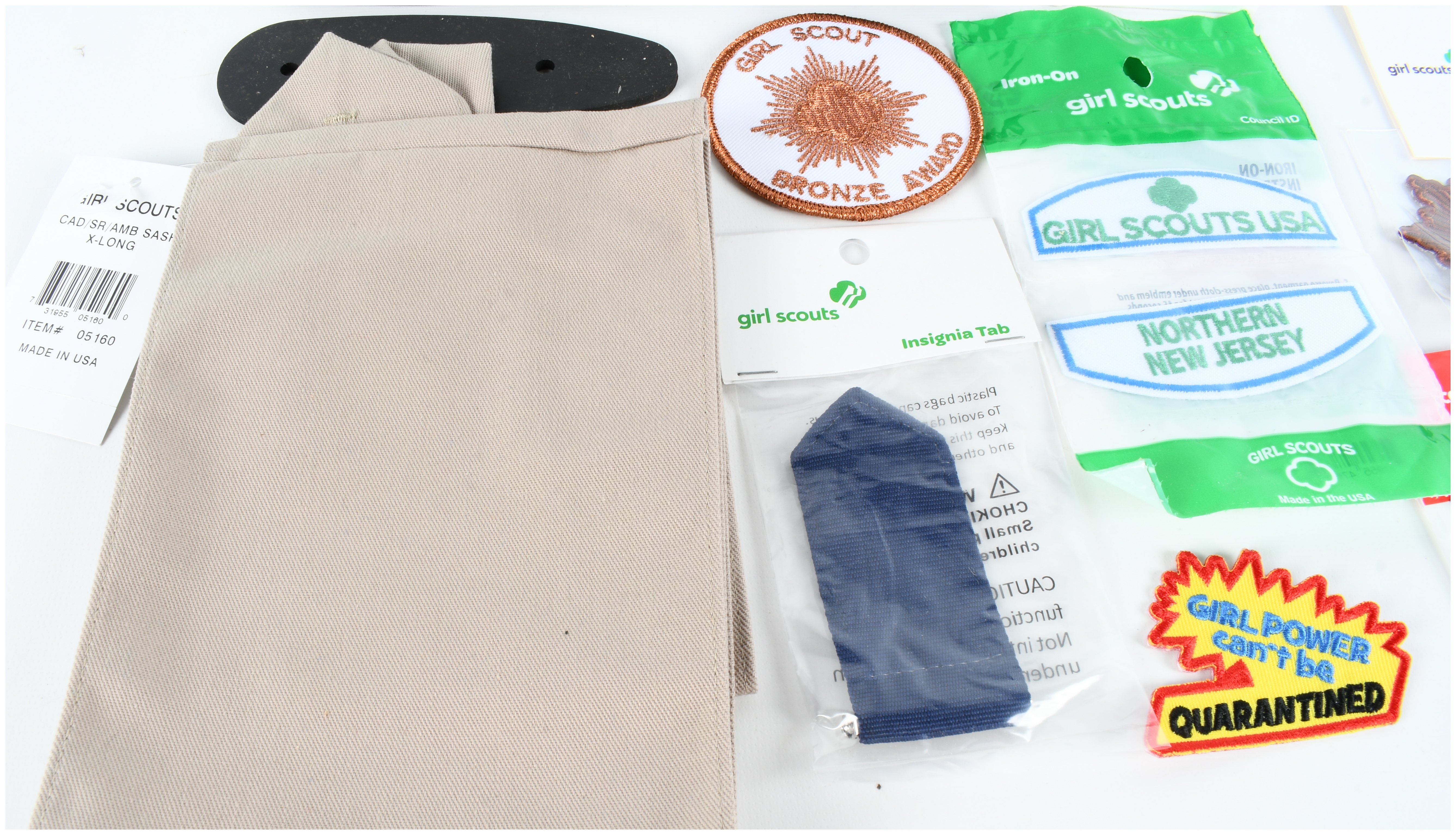 An Assortment of Firearm Recoil Pads, Girl Scout Memorabilia, and Full Deck Apocalypse Now Death Cards