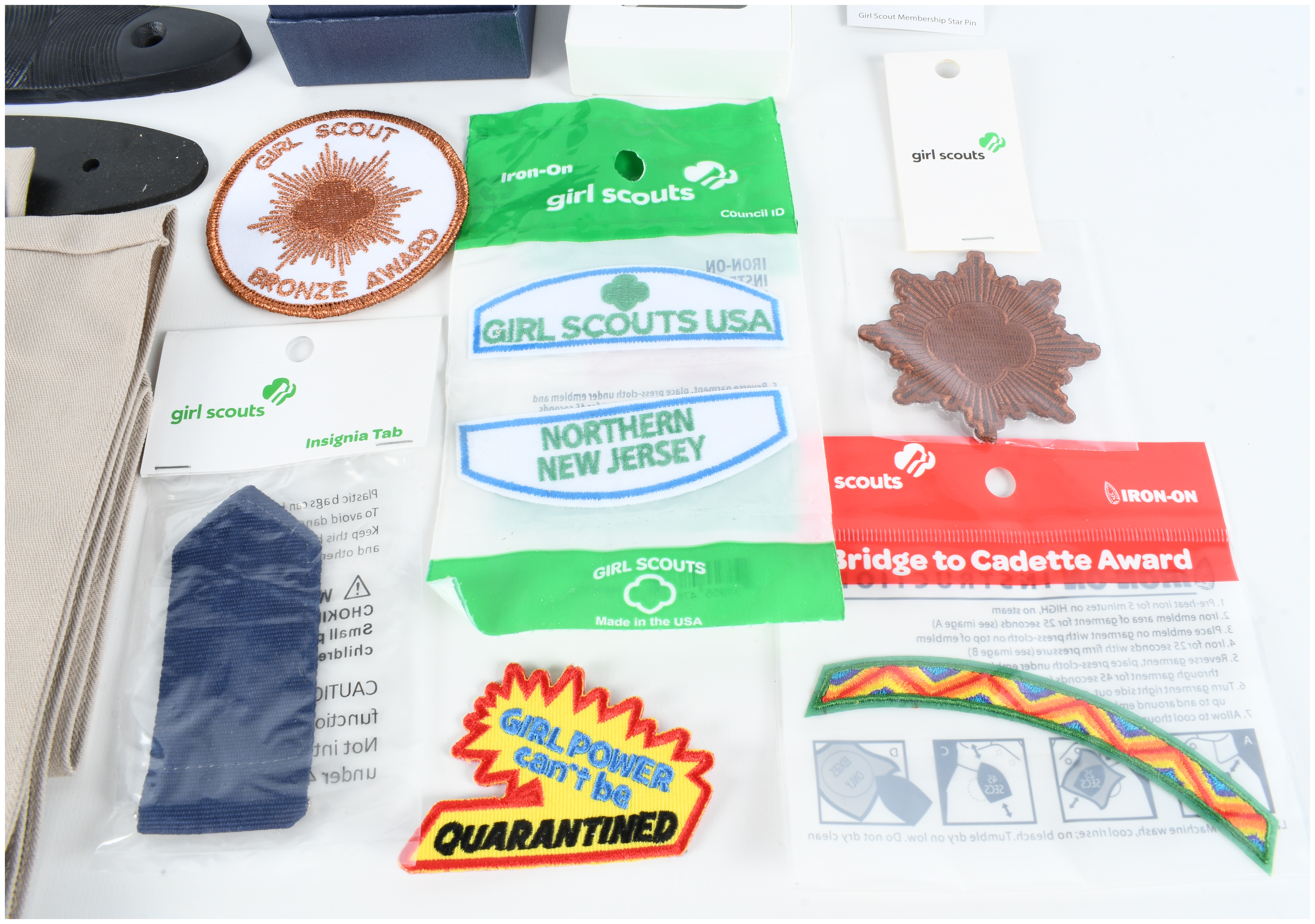 An Assortment of Firearm Recoil Pads, Girl Scout Memorabilia, and Full Deck Apocalypse Now Death Cards