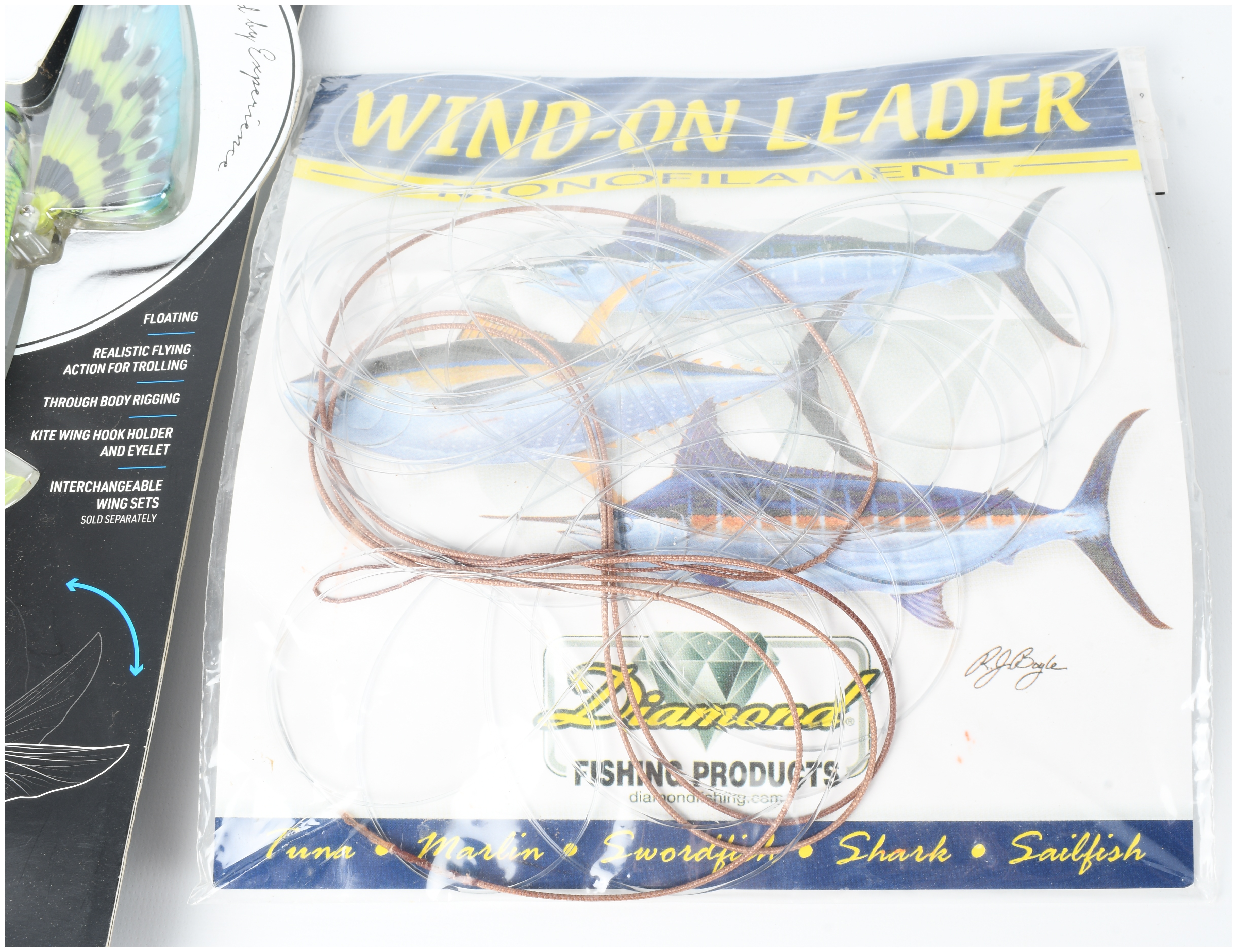Three Pieces of Offshore Fishing Tackle Including Nomad Design Slipstream Flying Fish Lures and Diamond Leader