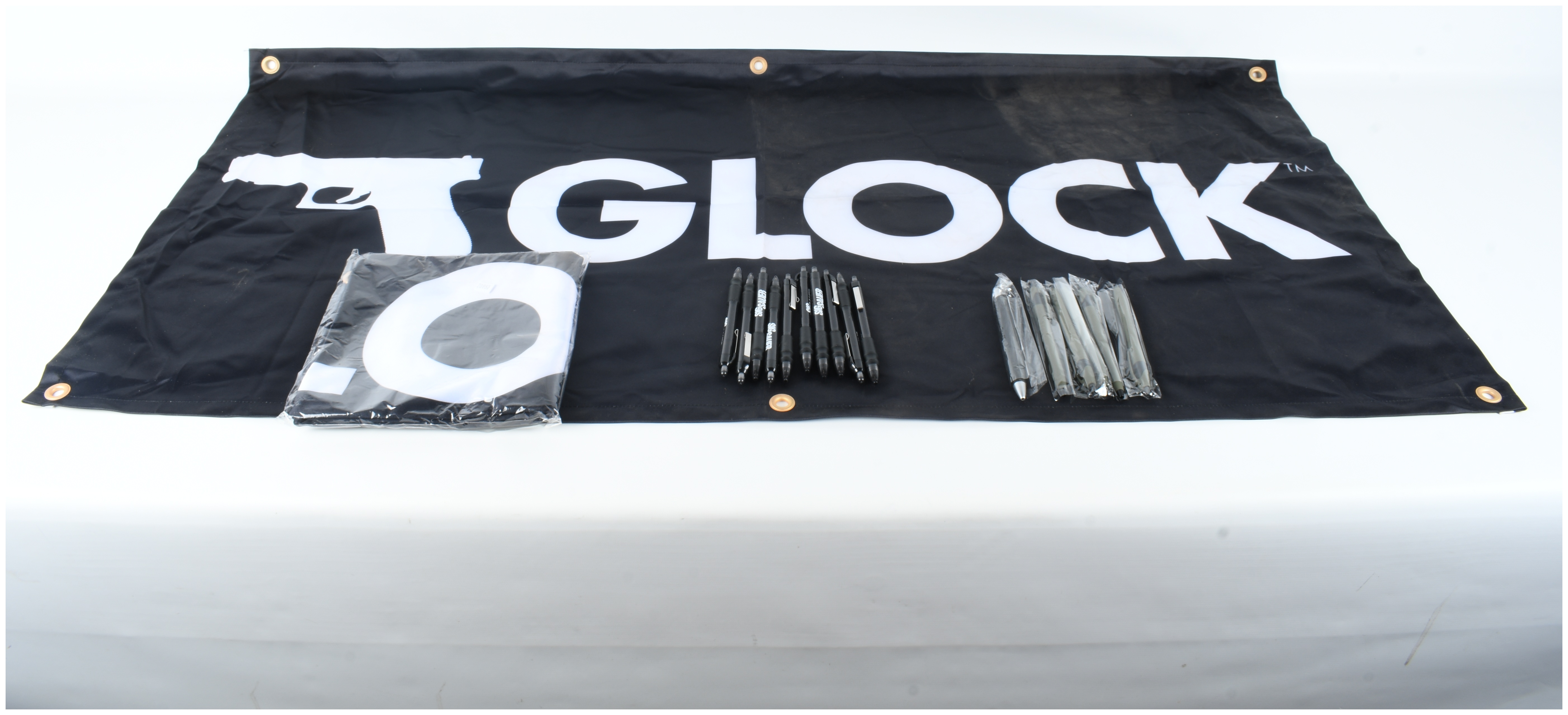 A Collection of Glock and Sig Sauer Promotional Merchandise Including Banners and Pens
