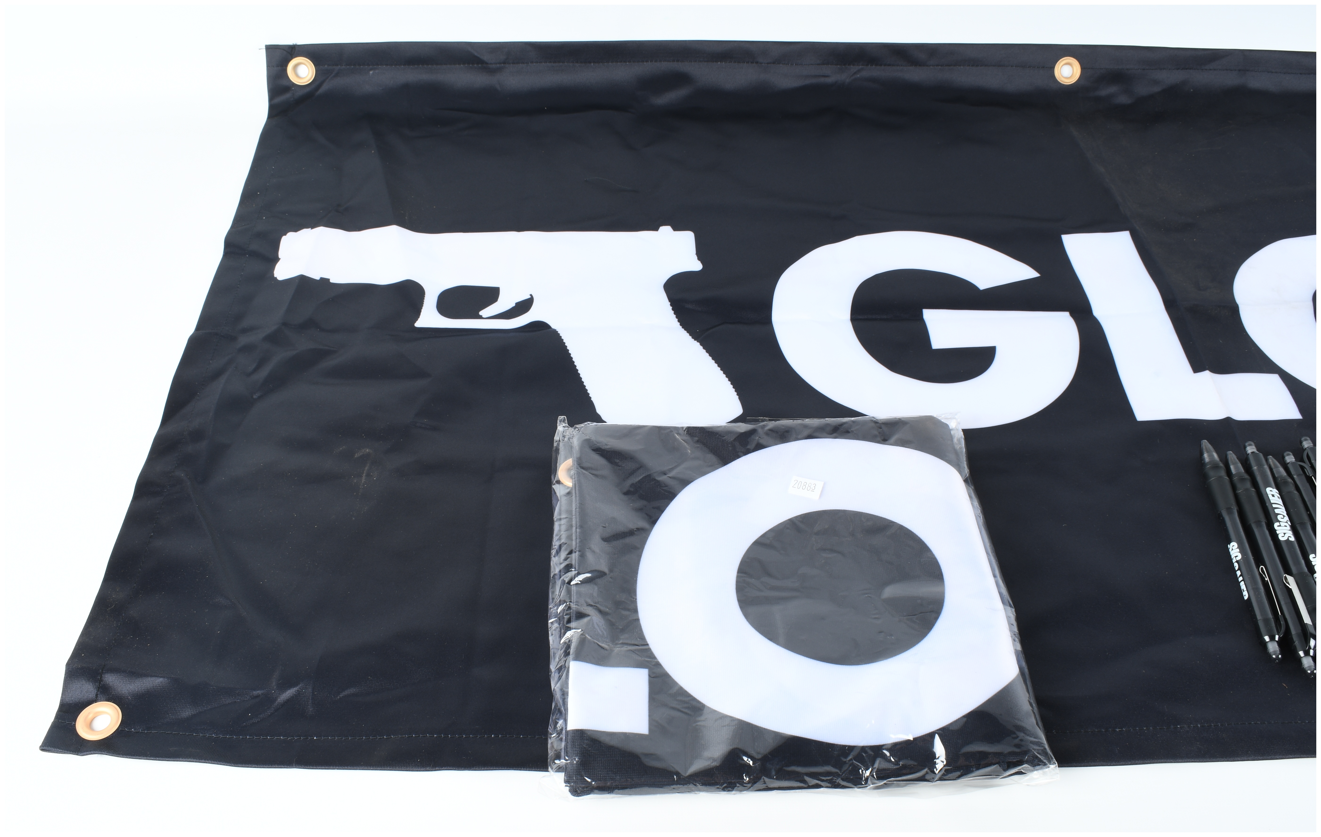 A Collection of Glock and Sig Sauer Promotional Merchandise Including Banners and Pens