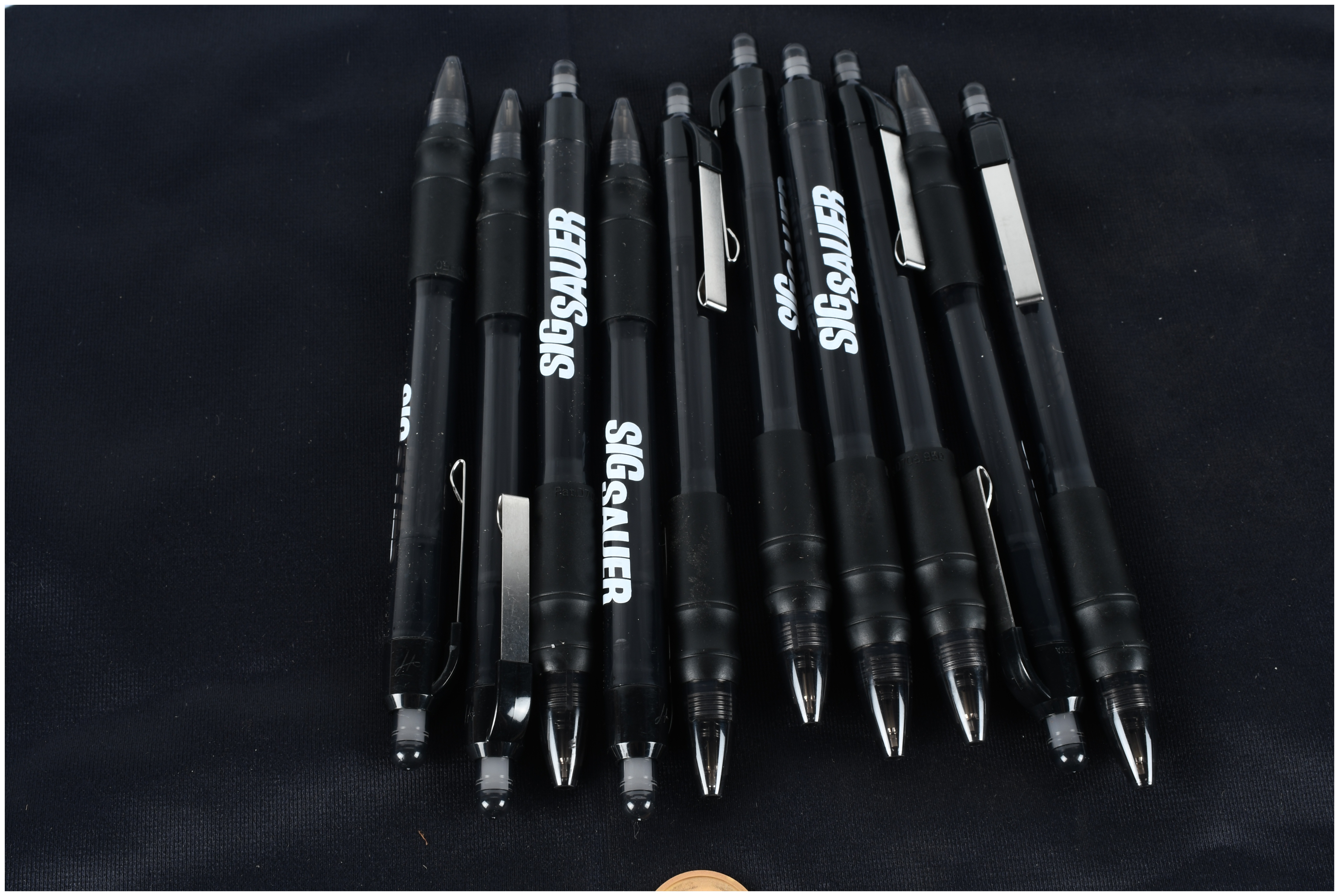 A Collection of Glock and Sig Sauer Promotional Merchandise Including Banners and Pens