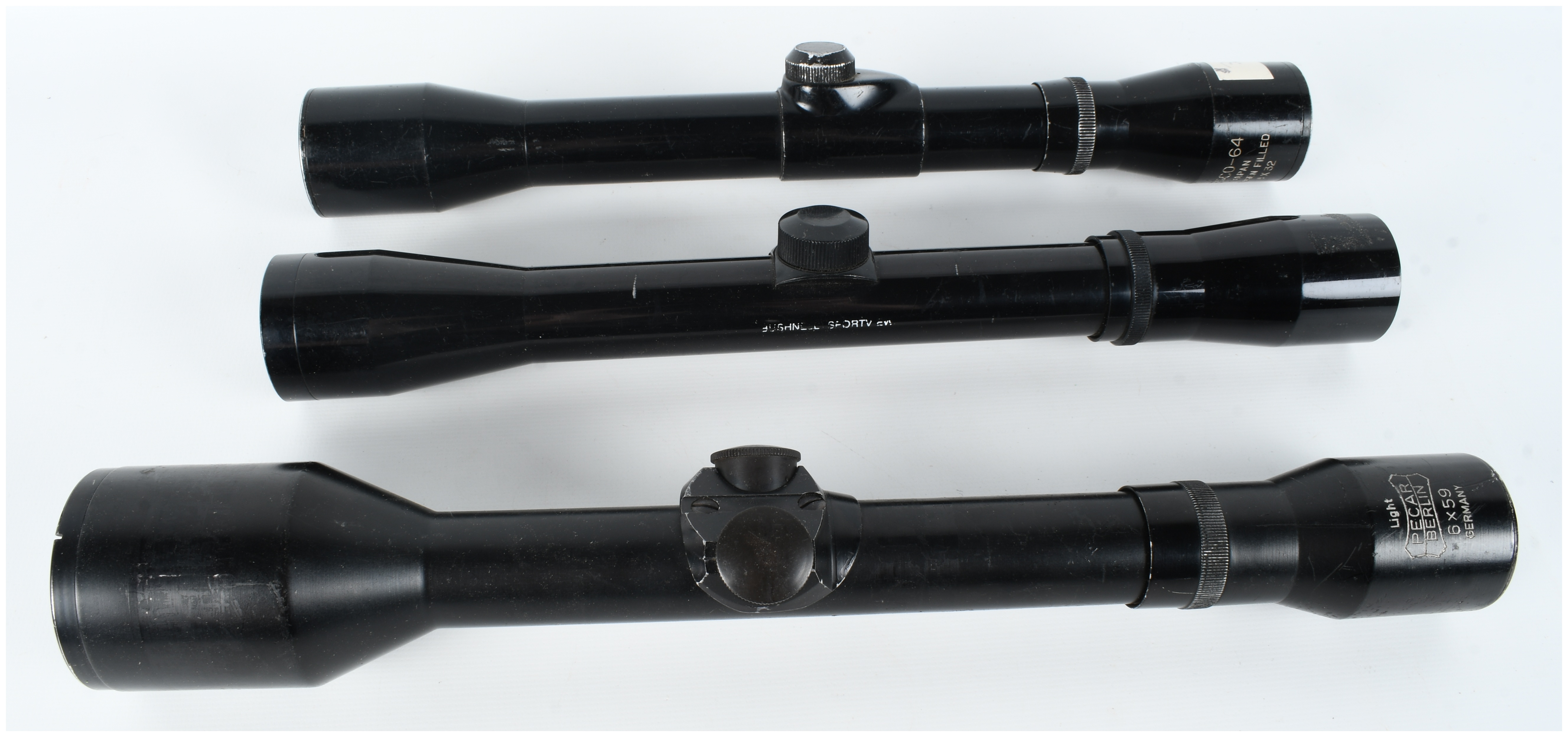 A Collection of Three Rifle Scopes Including Pecar Berlin, Bushnell Sportview, and Wesco-64