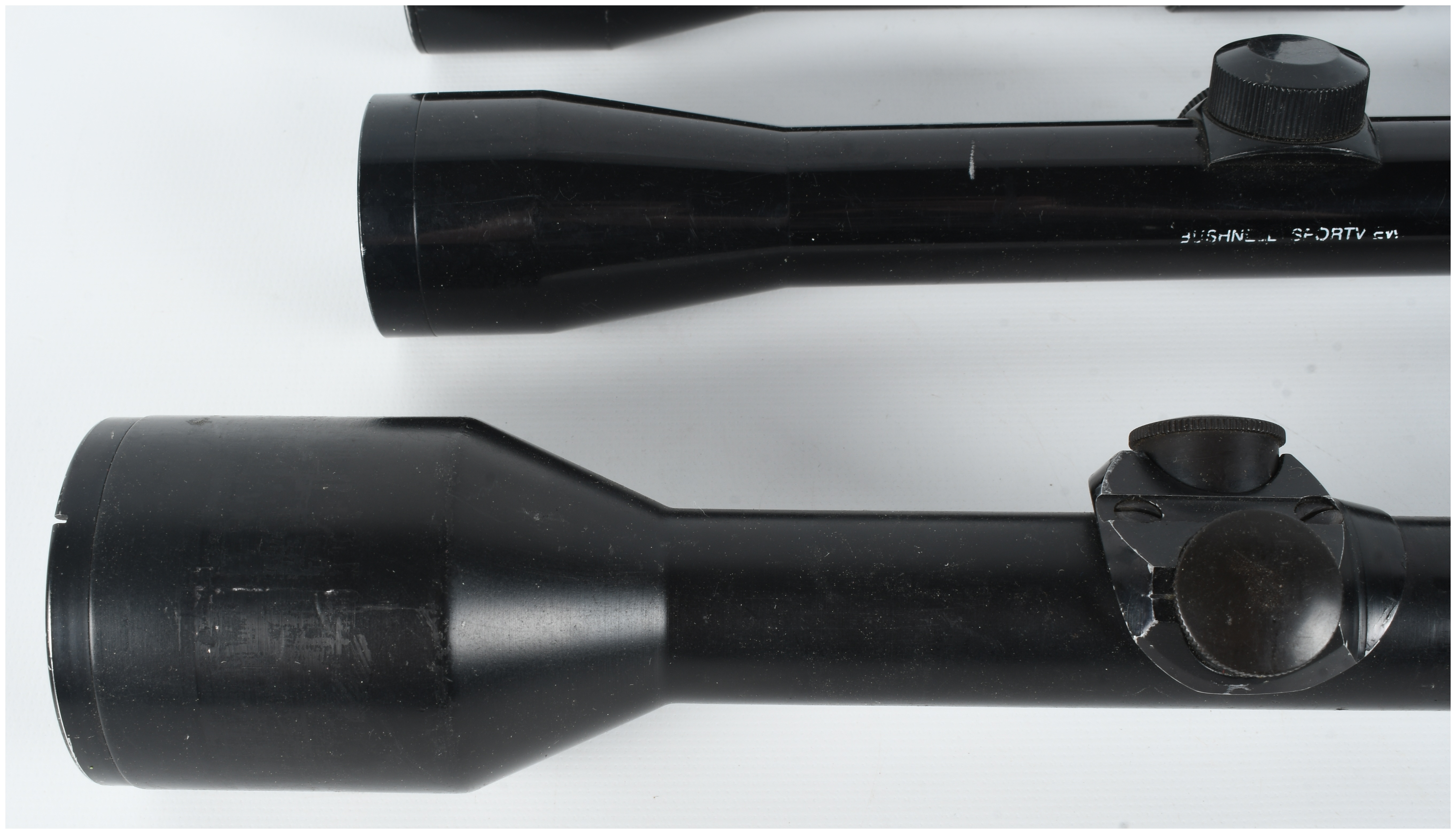 A Collection of Three Rifle Scopes Including Pecar Berlin, Bushnell Sportview, and Wesco-64