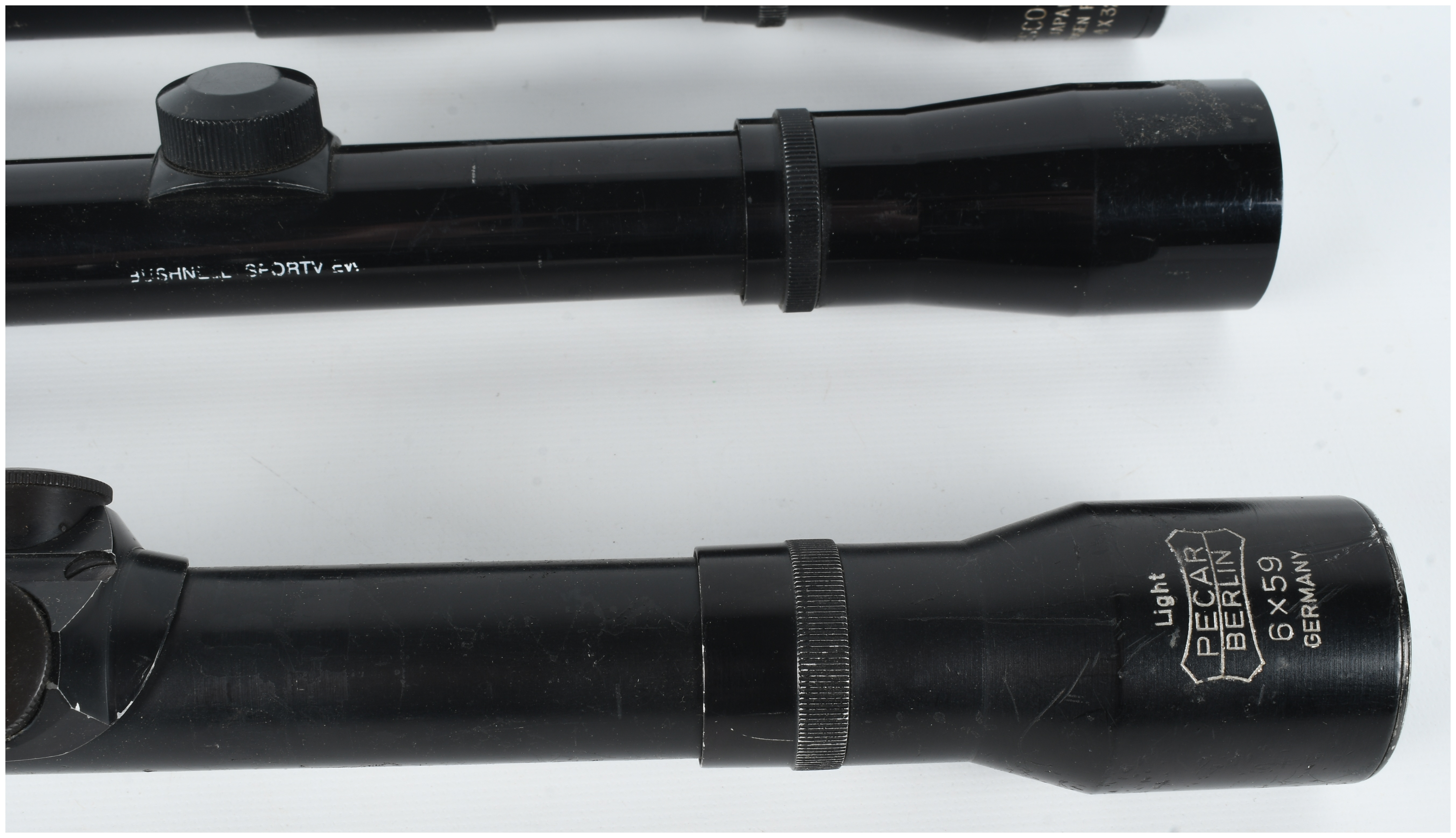 A Collection of Three Rifle Scopes Including Pecar Berlin, Bushnell Sportview, and Wesco-64