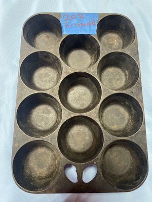 Griswold No. 10 Cast Iron Muffin Pan. A dark grey/black cast iron muffin pan, marked "Griswold" 