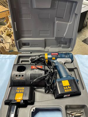 A Set of Ryobi 14.4V Cordless Drill, Charger, and Batteries. A blue, gray, and black Ryobi 14.4V 