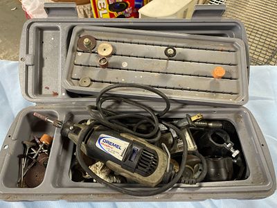 A Dremel MultiPro Model 395 Rotary Tool with Accessories and Case. A gray and black Dremel 