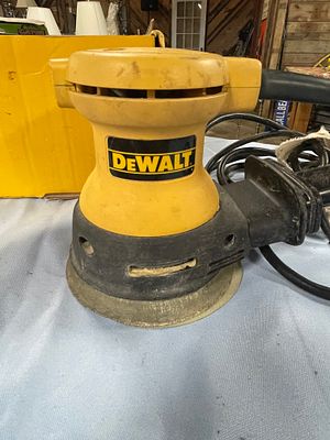 DEWALT DW421 Random Orbit Palm Sander with Discs and Boxes. A yellow and black DEWALT DW421 
