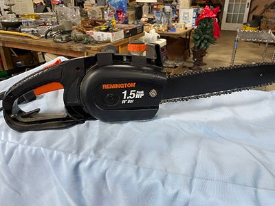 Remington 1.5 Peak HP 14" Bar Electric Chainsaw. A black and orange Remington 1.5 Peak HP 14" 