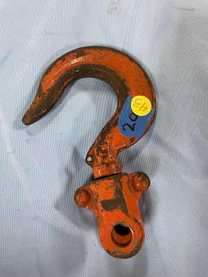 An Orange Forged Alloy Heavy-Duty Lifting Hook. An orange heavy-duty lifting hook, forged from 