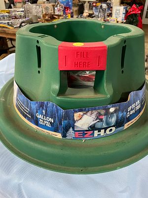 A Green Plastic Christmas Tree Stand for 8 ft. Trees. A green EZHO Christmas tree stand with red 
