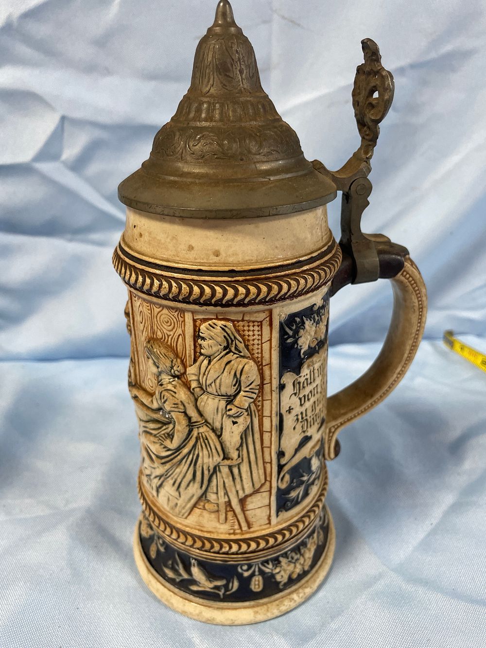 Lot 175: A German Lidded Ceramic Beer Stein with Embossed Scenes