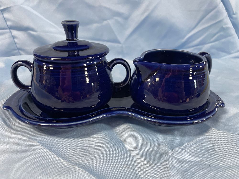 Lot 184: Homer Laughlin Fiesta Cobalt Blue Three-Piece Sugar, Creamer, and Tray Set