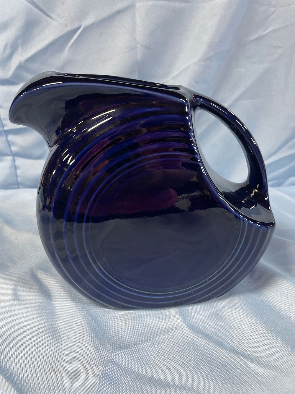 Lot 186: Fiesta Cobalt Blue Disk Pitcher by Homer Laughlin, 7.5 inches