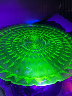 A Green Pressed Uranium Glass Serving Plate. A round, green pressed glass serving plate or 