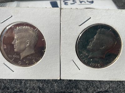 A Pair of Kennedy Half Dollar S Mint Proof Coins. A pair of silver-toned Kennedy Half Dollars 