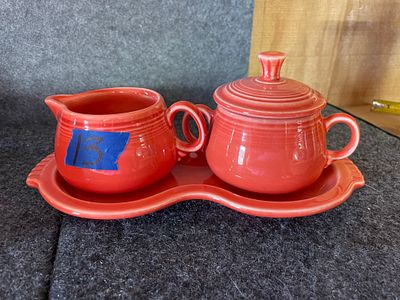 Fiesta Ceramic Cream and Sugar Set with Tray. A three-piece orange-red ceramic set featuring a 