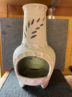 Ceramic Palo Santo Mini Chiminea with Leaf Cutouts. A cream-colored textured ceramic Palo Santo 