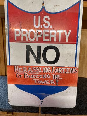 US Property No Trespassing Metal Sign with Novelty Message. A rectangular red, white, and blue 