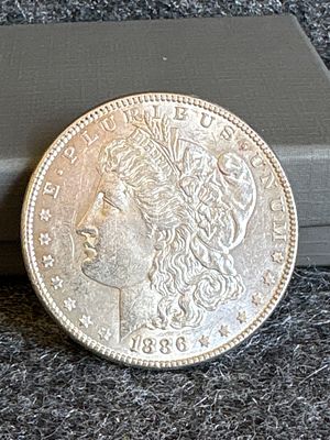 1886 Morgan Silver Dollar Coin. An 1886 Morgan silver dollar coin featuring Lady Liberty on the 