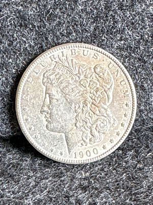 1900 Morgan Silver Dollar Coin. A 1900 Morgan silver dollar coin featuring Lady Liberty on the 