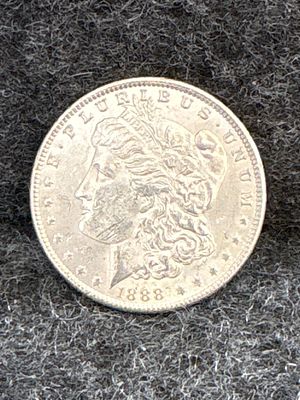 1888 Morgan Silver Dollar. An 1888 Morgan silver dollar featuring Liberty on the obverse and an 