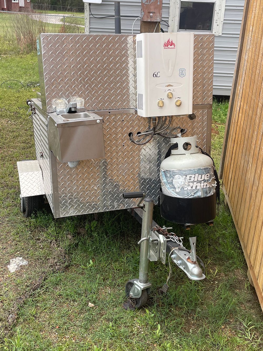 The USA Trailer Store Towable Hot Dog Cart Trailer. A silver diamond-plate towable hot dog cart 