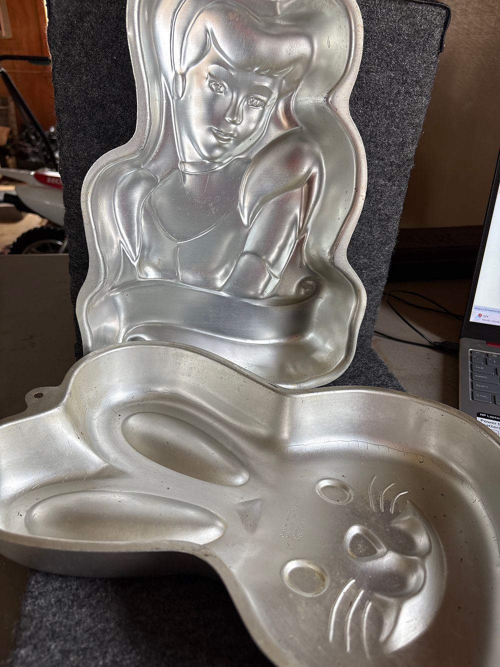 A Collection of Wilton Aluminum Character Cake Pans. A collection of silver-colored aluminum 