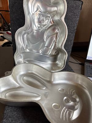 A Collection of Wilton Aluminum Character Cake Pans. A collection of silver-colored aluminum 