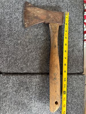 Vintage Hatchet with Weathered Wooden Handle and Rusted Head. A vintage hatchet featuring a 