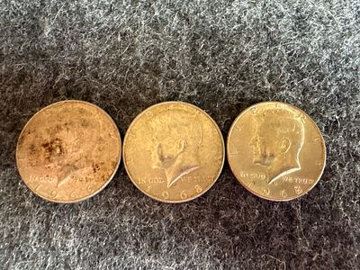 A Trio of United States Kennedy Half Dollar Coins. A trio of silver-toned United States Kennedy 