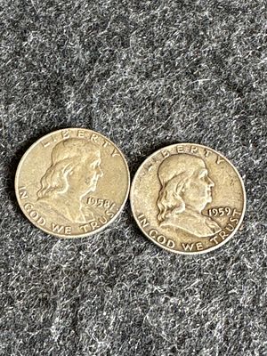 A Pair of 1958 and 1959 Franklin Half Dollars. A pair of silver-toned United States Franklin 