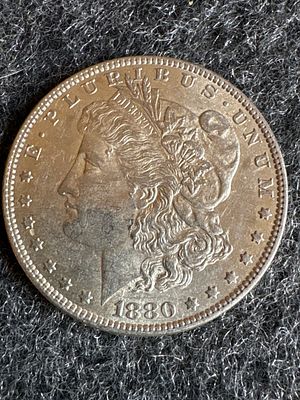 1880-O Morgan Silver Dollar Coin. A silver 1880-O Morgan Silver Dollar featuring an eagle 