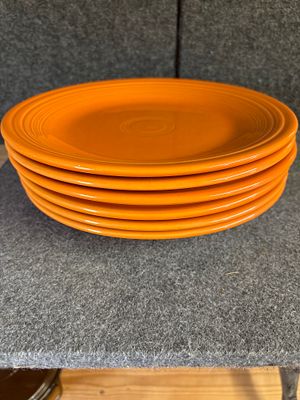 A Collection of Homer Laughlin Fiestaware Orange Ceramic Plates. A collection of orange ceramic 