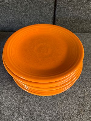 A Collection of Homer Laughlin Fiesta Orange Ceramic Saucers. A collection of orange ceramic 