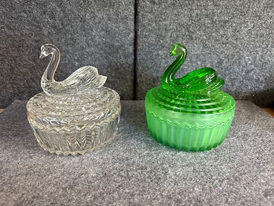 A Pair of Jeannette Glass Swan powder Boxes. A pair of glass swan powder boxes with matching 